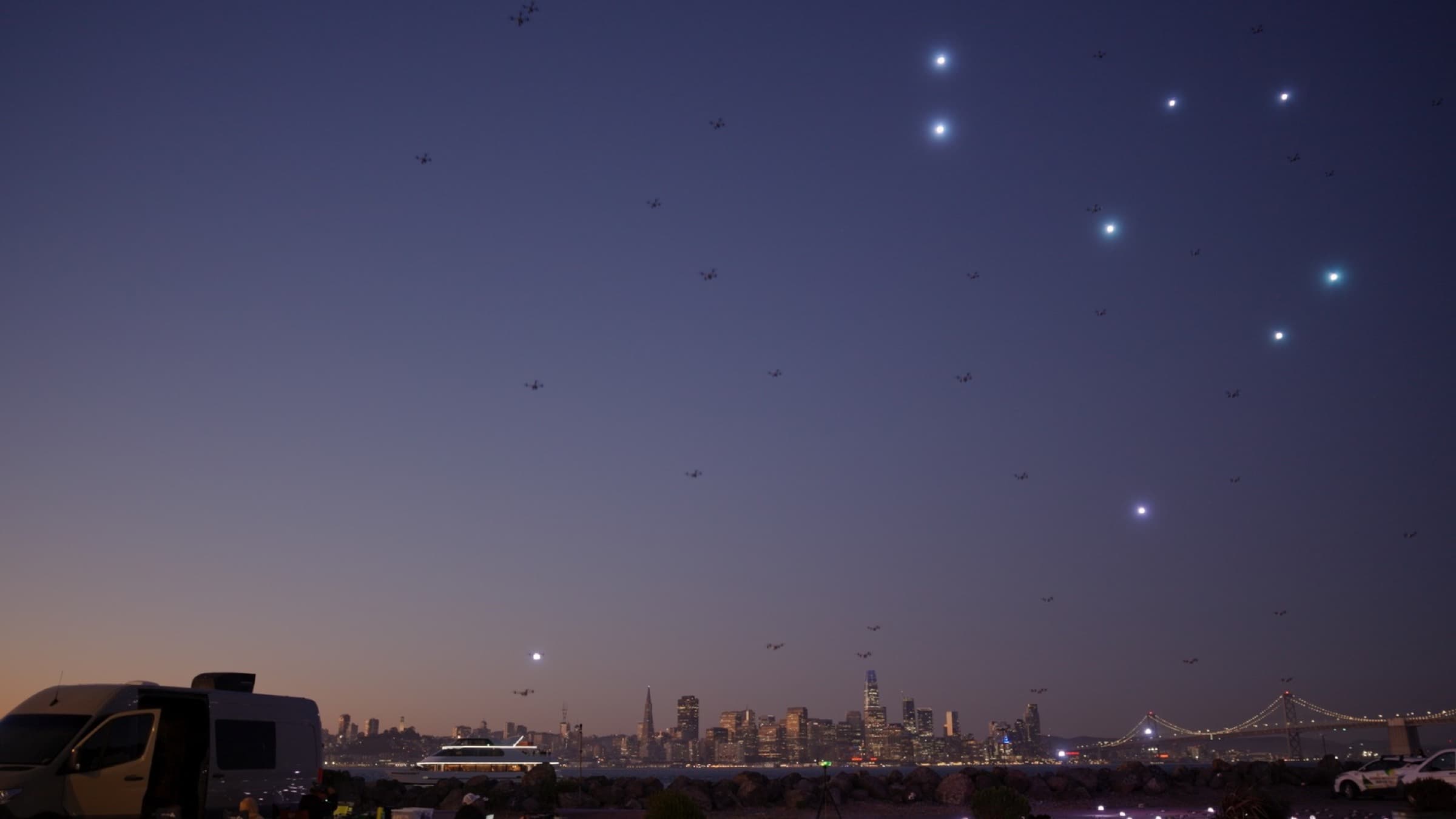 Drones over San Francisco Bay at dusk, launch van on the shore