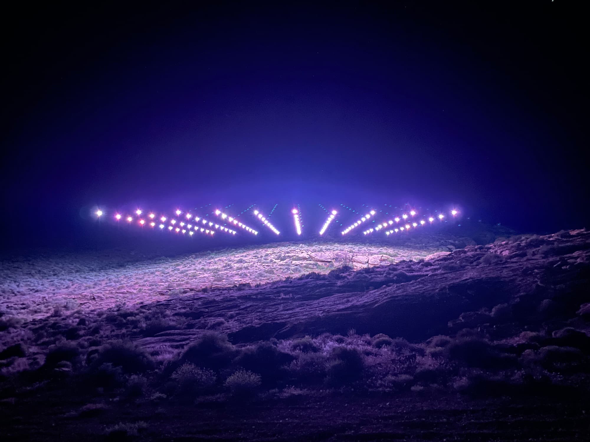 The launch grid lit on the desert floor at night, the fleet throwing rays up into the dark
